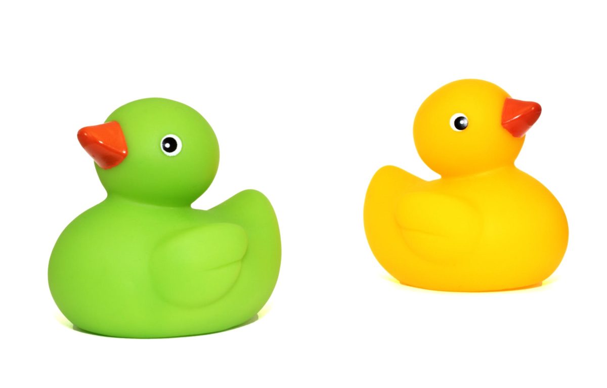 yellow duck toy beside green duck toy