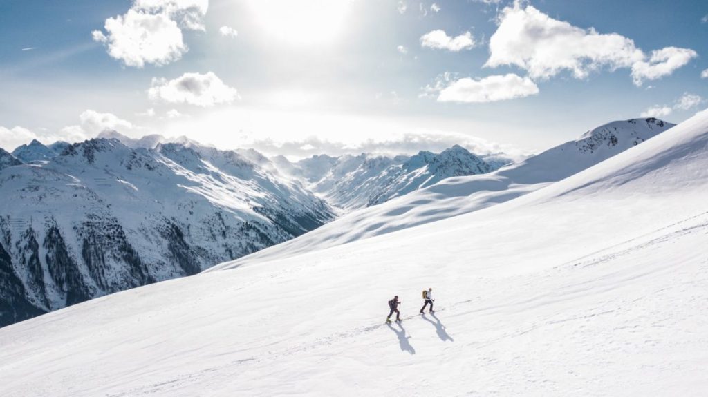 two man hiking on snow mountain
