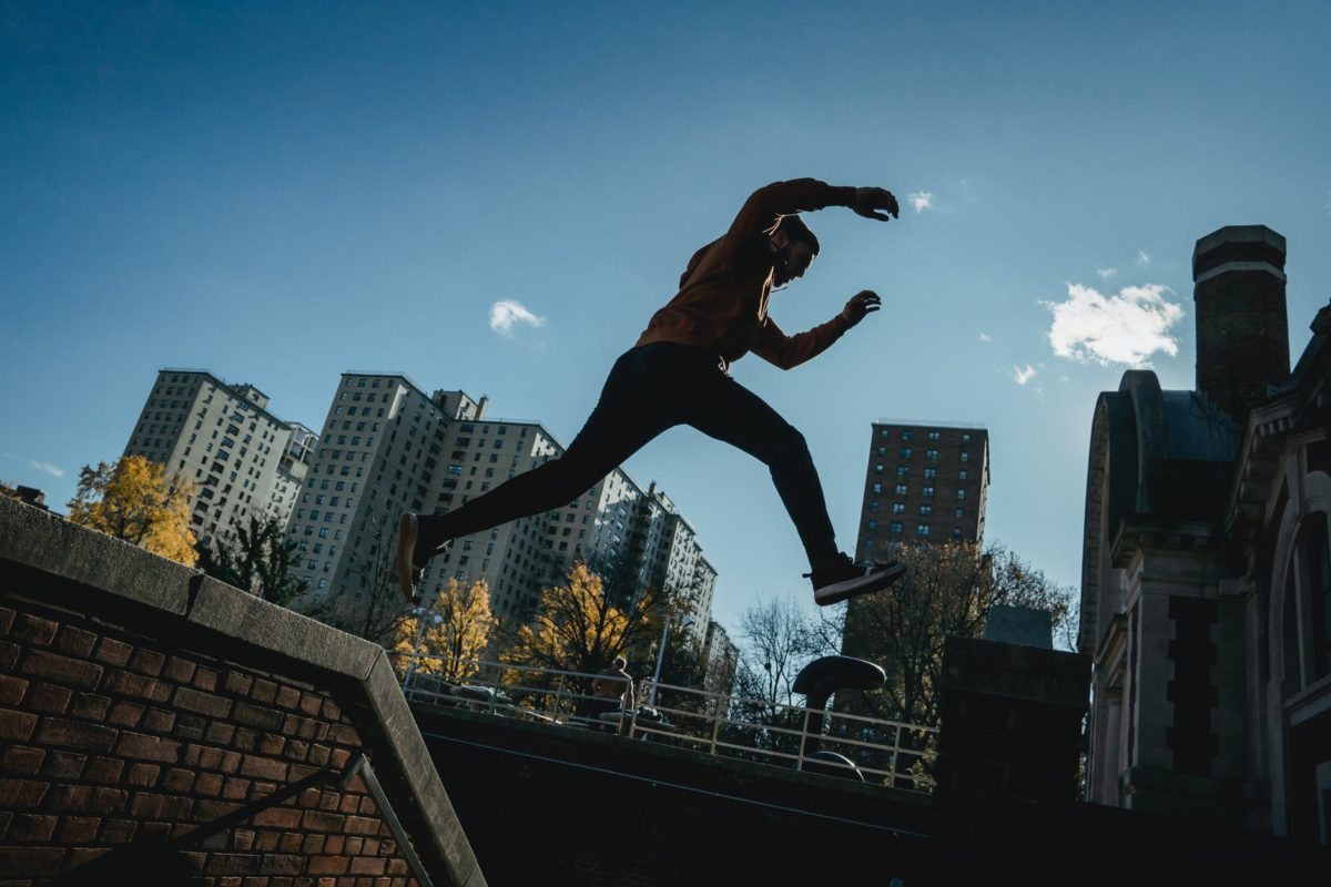 energetic man jumping on street