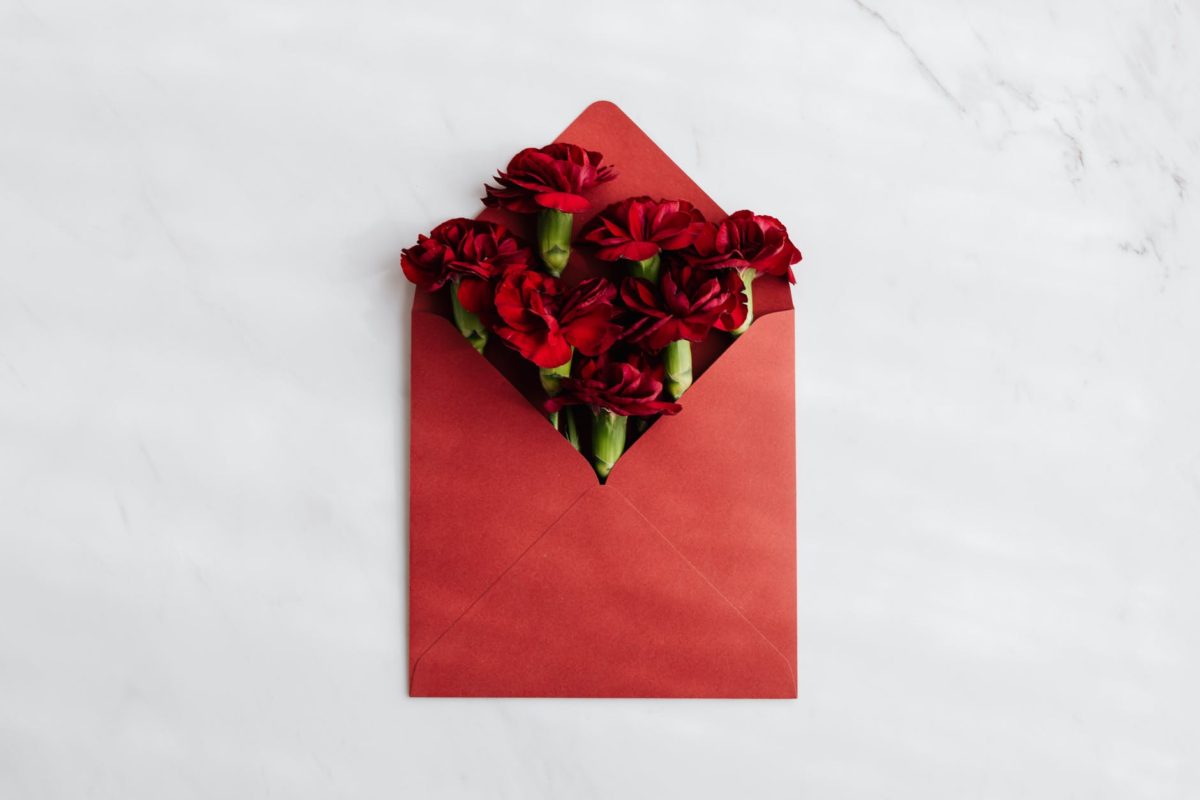 red envelope with fresh red flowers inside