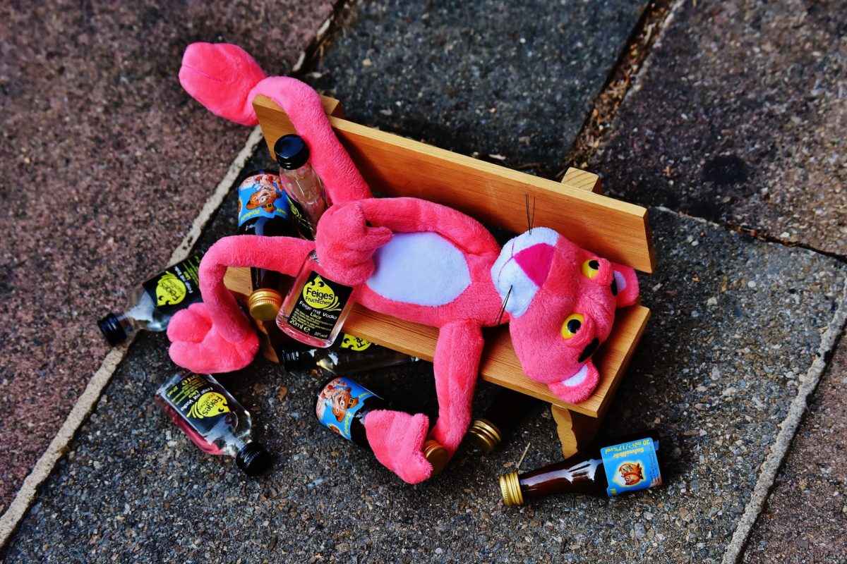 pink panther plush toy on brown bench miniature